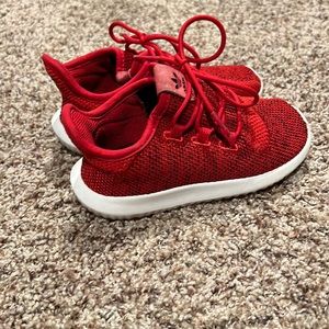 Selling a red pair of Adidas shoes